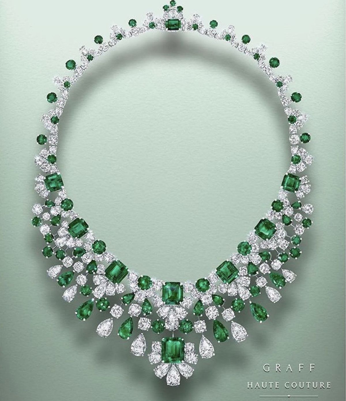A broad necklace with green-toned accents and a central drop.