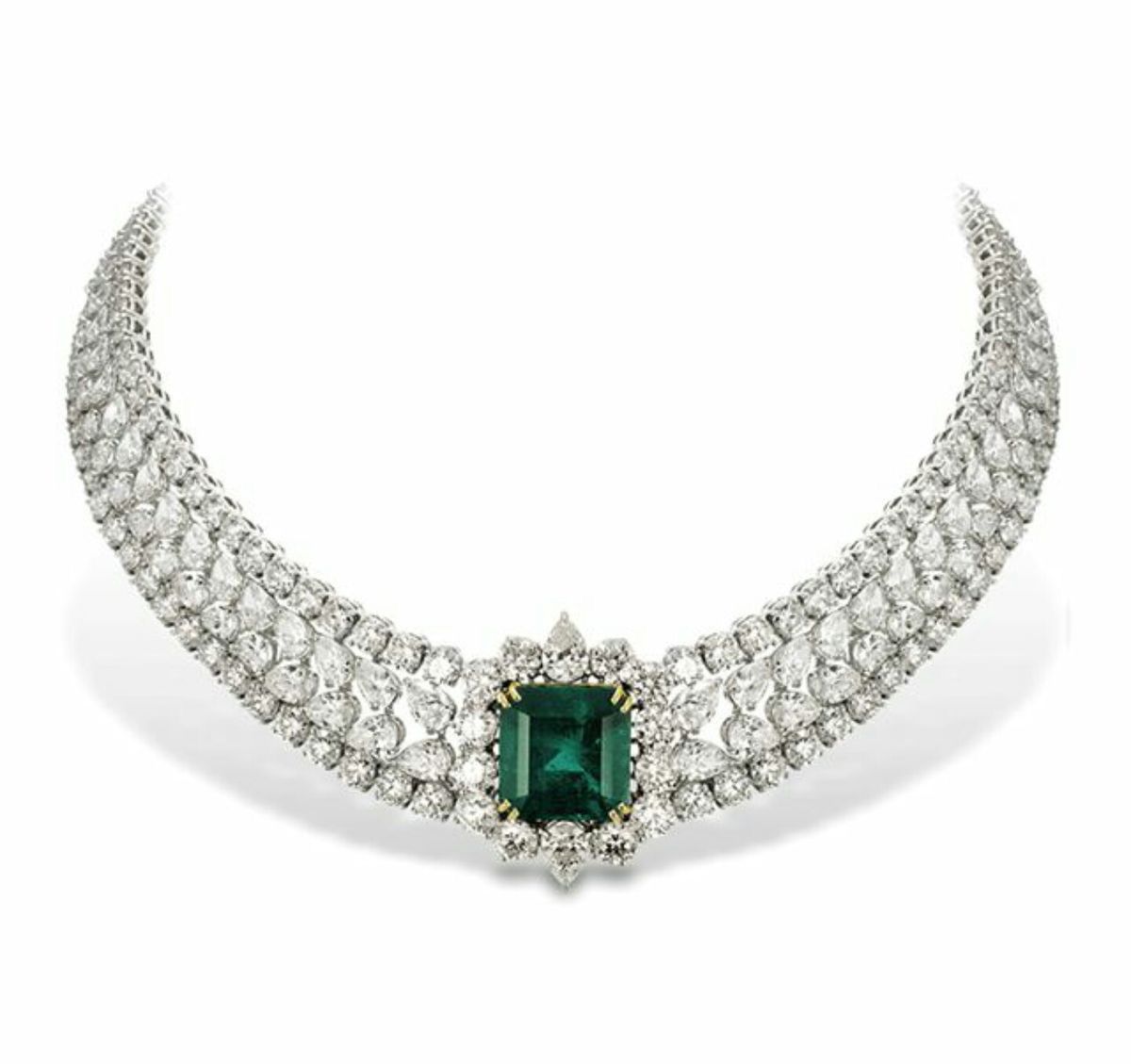 A curved pale necklace with a rectangular green-toned center detail.
