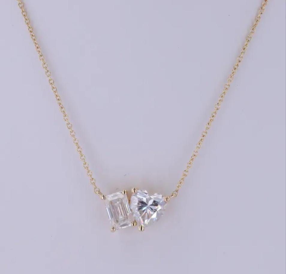 A fine necklace with a two-part pale pendant in a geometric arrangement.