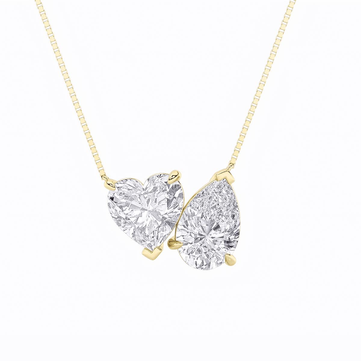 A fine chain necklace with two adjoining heart-shaped pendant forms.