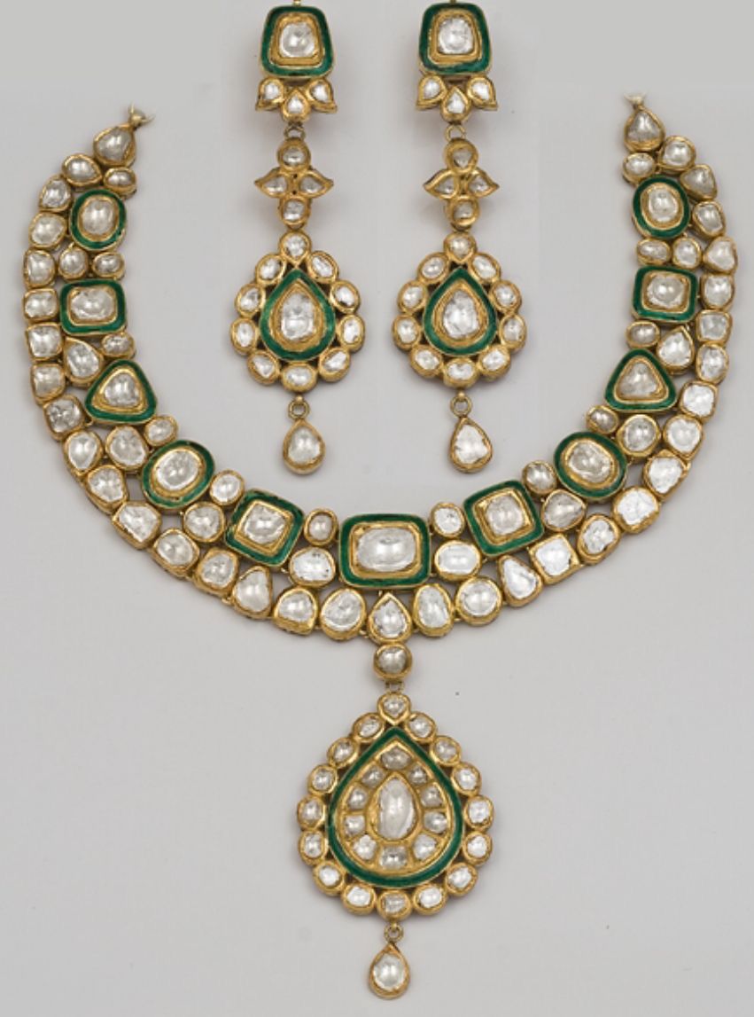 A necklace with green-framed details and a large drop pendant, shown with matching earrings.