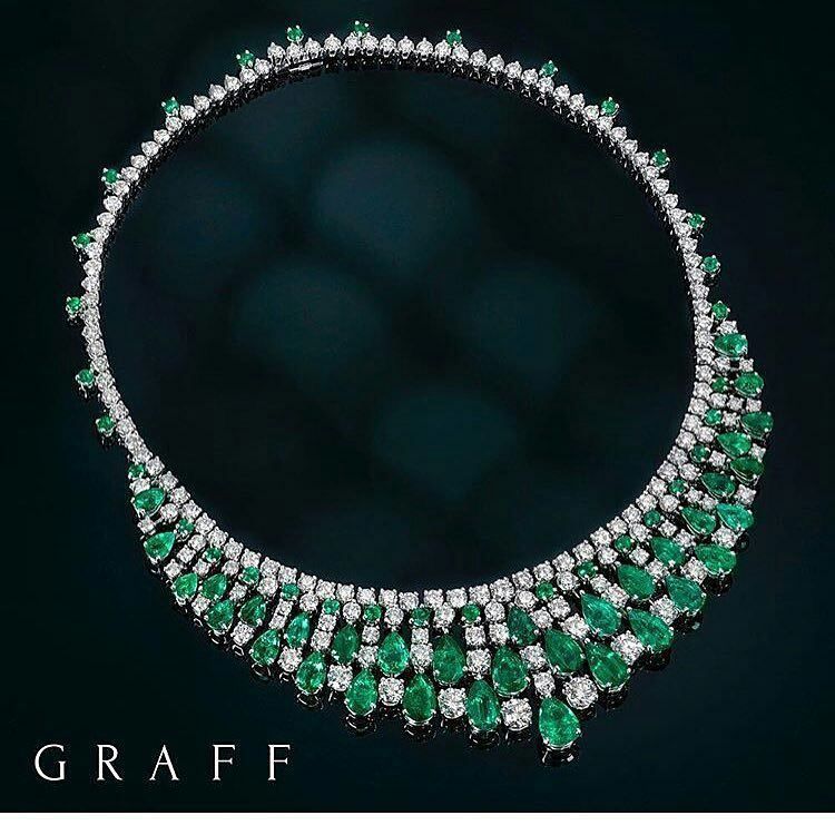 A broad necklace with close-set green-toned square details.