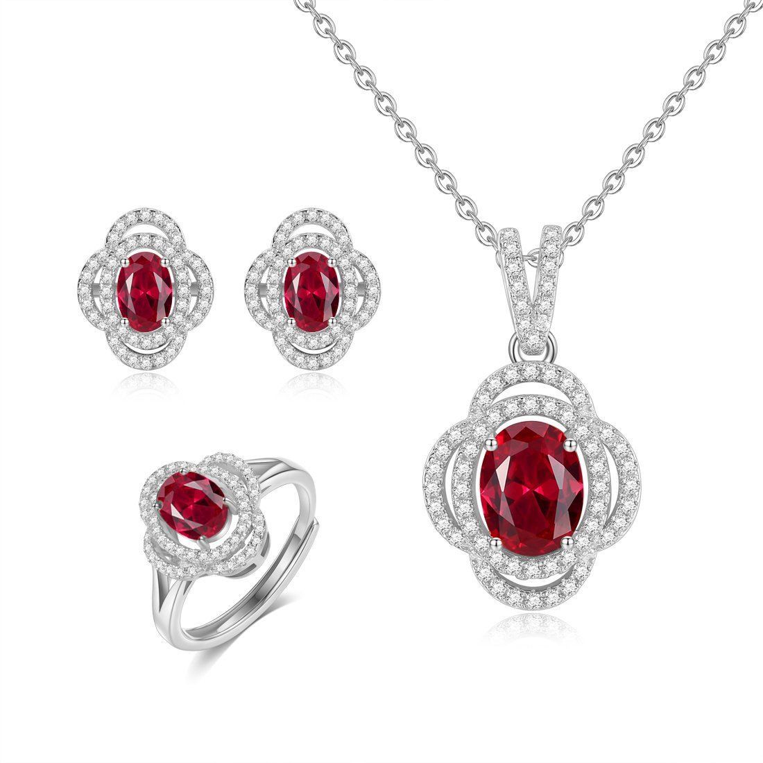 A coordinated display of necklace, earrings, and ring with red-toned oval details.
