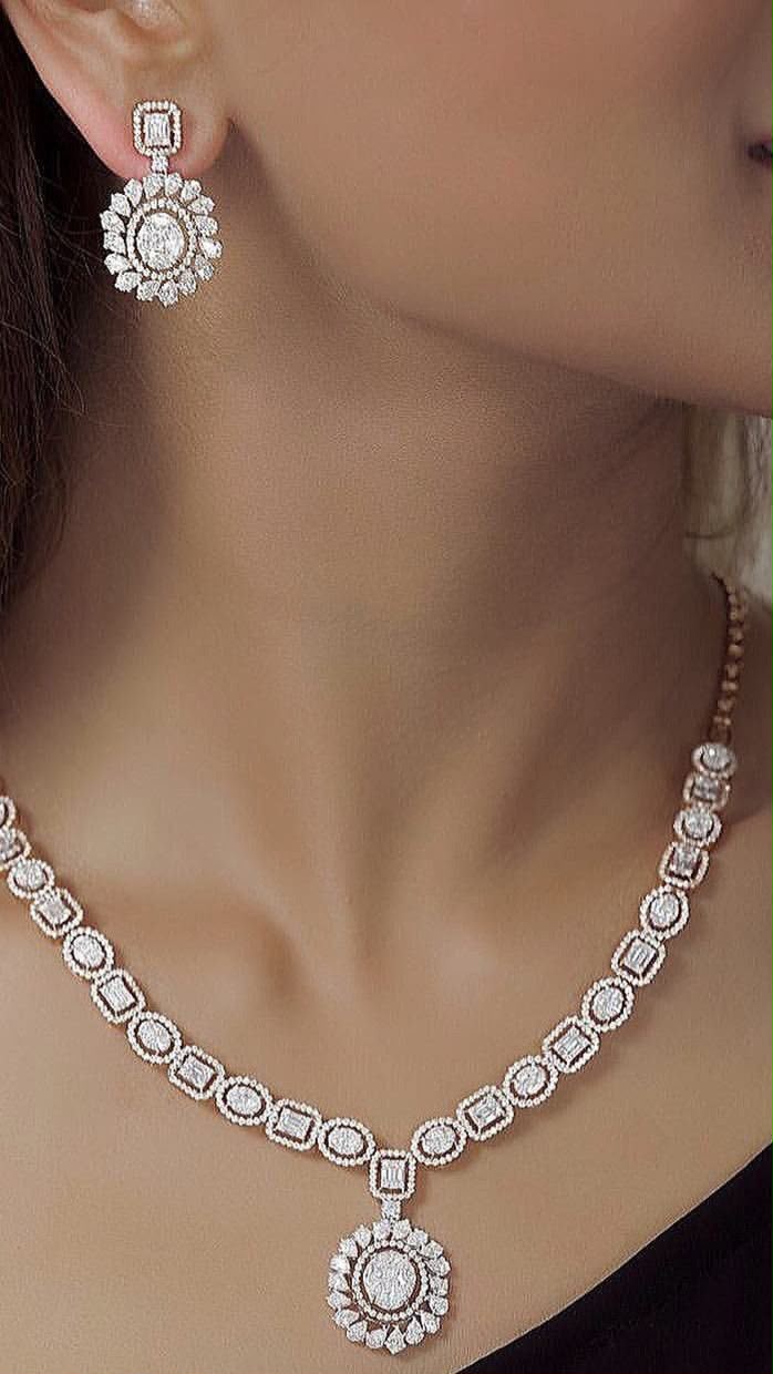 A necklace with a round center pendant, shown with matching earrings.