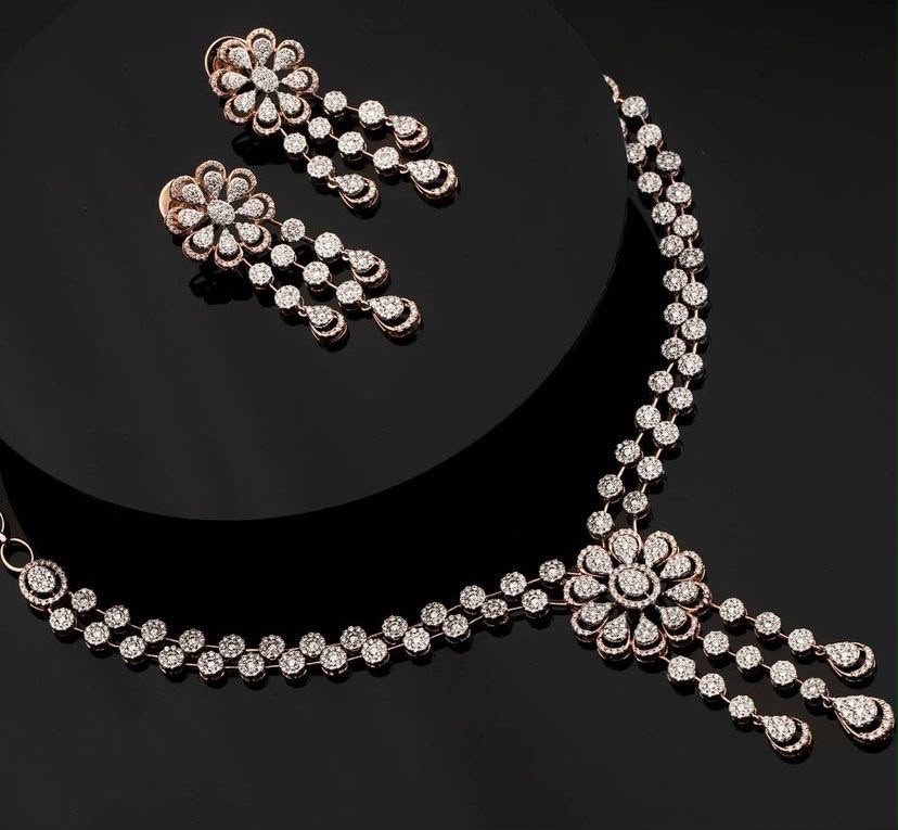 A necklace with floral center details, shown with matching earrings.