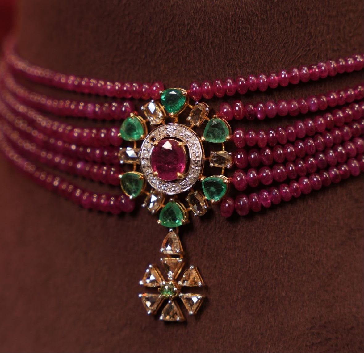 Several red-toned rows surround a large center detail and hanging ornament.
