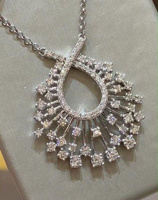 A fine necklace with an open teardrop-shaped center and radiating details.