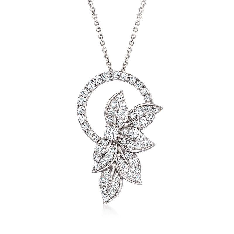 A necklace with a circular frame and a flower-shaped pendant detail.