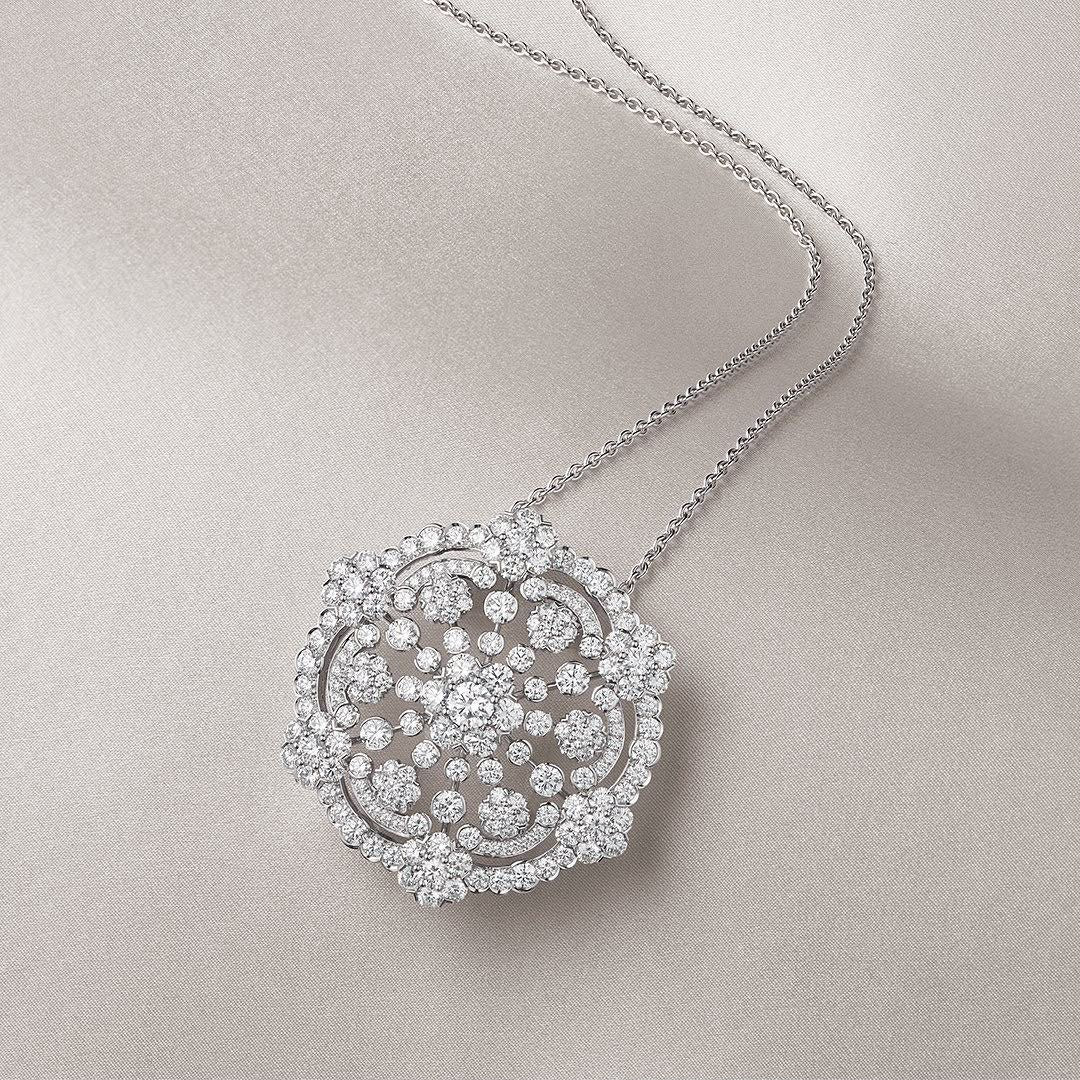 A fine necklace with a round floral medallion pendant.