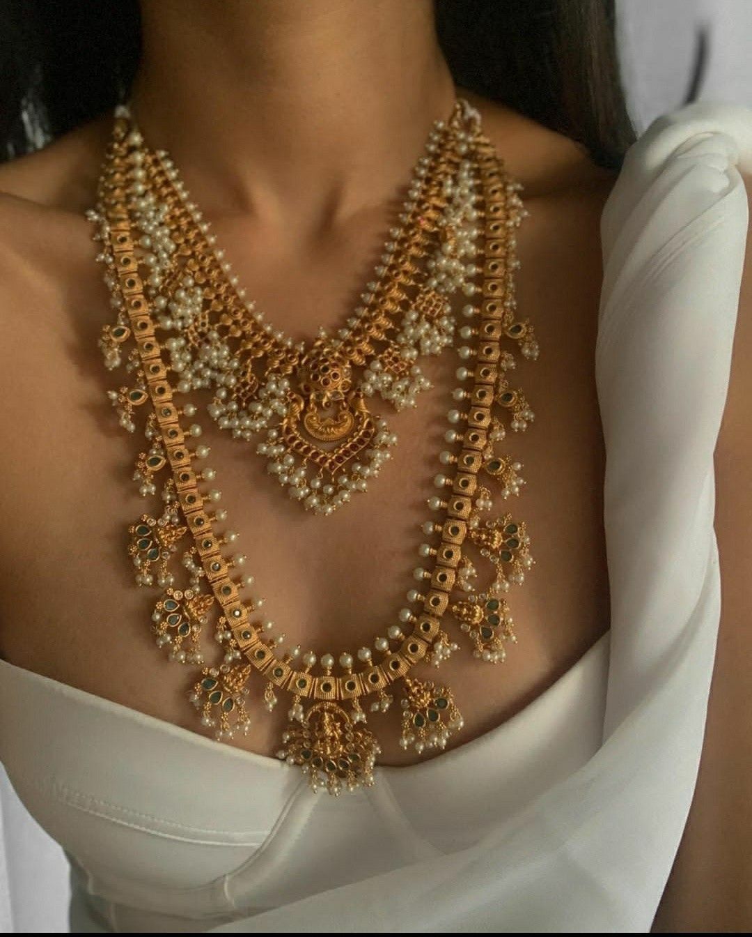 multiple warm-toned chains arranged in graduated lengths
