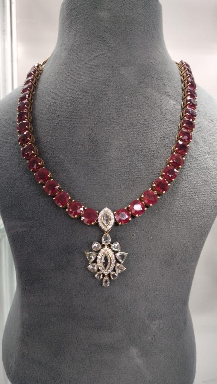 a red-toned center on a necklace chain
