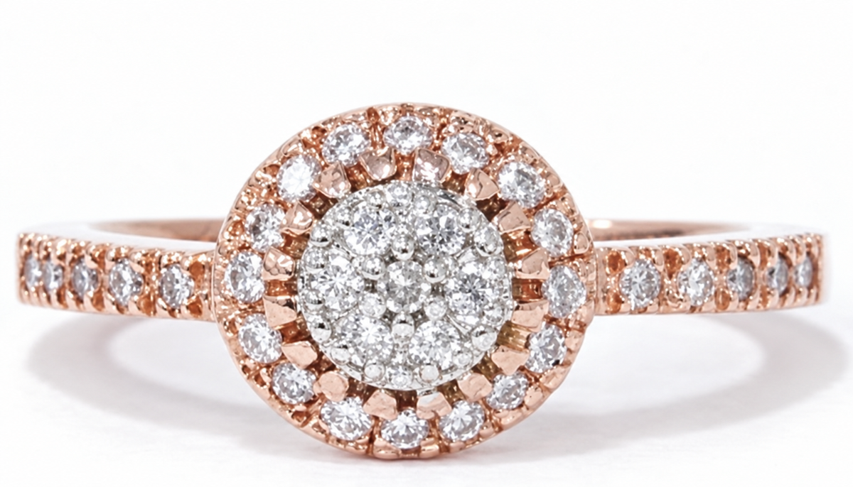 A circular mosaic of small clear stones is framed by a halo and sparkling rose-coloured shoulders.