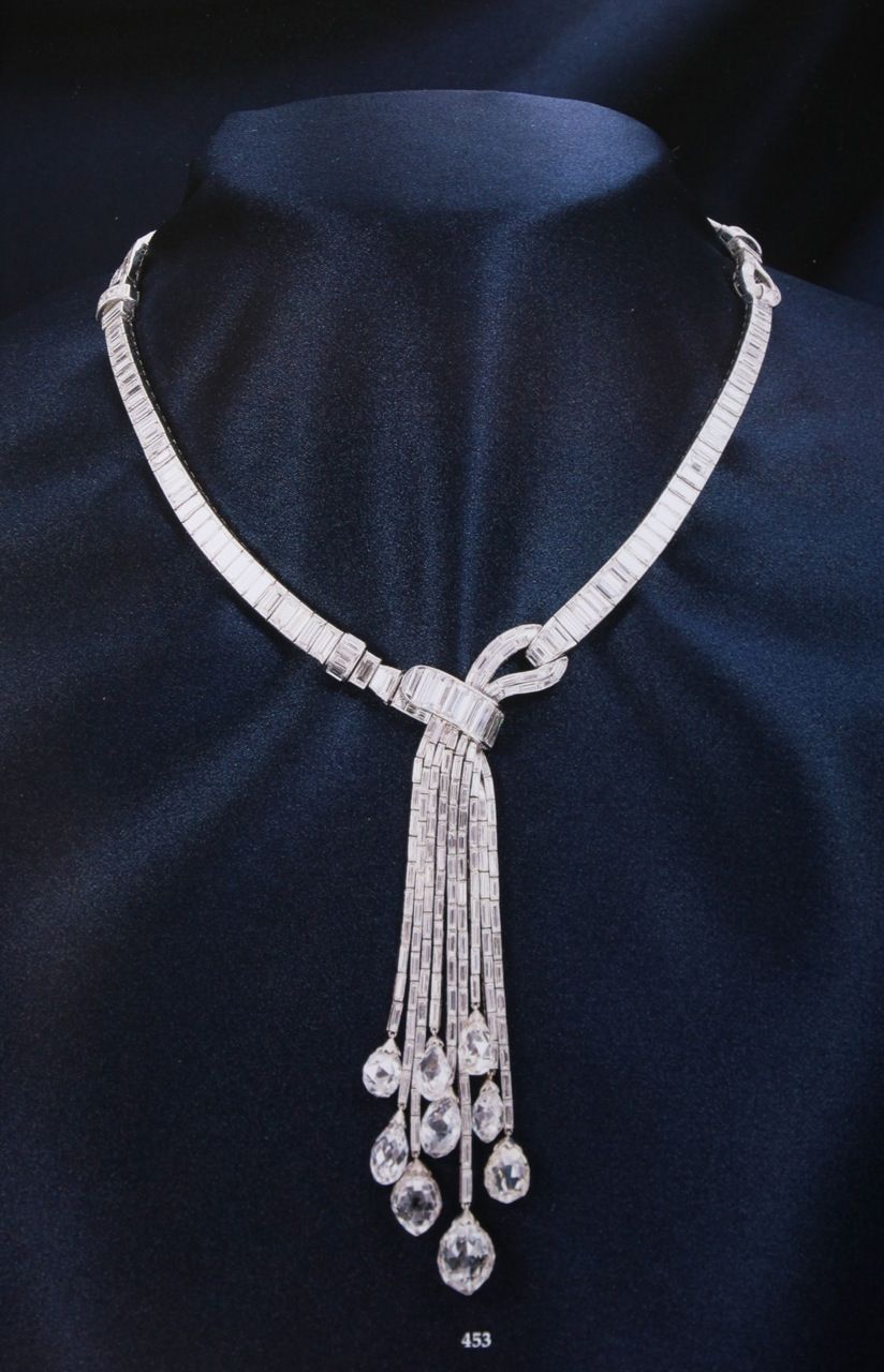 Necklace featuring a long center drop with fine hanging strands