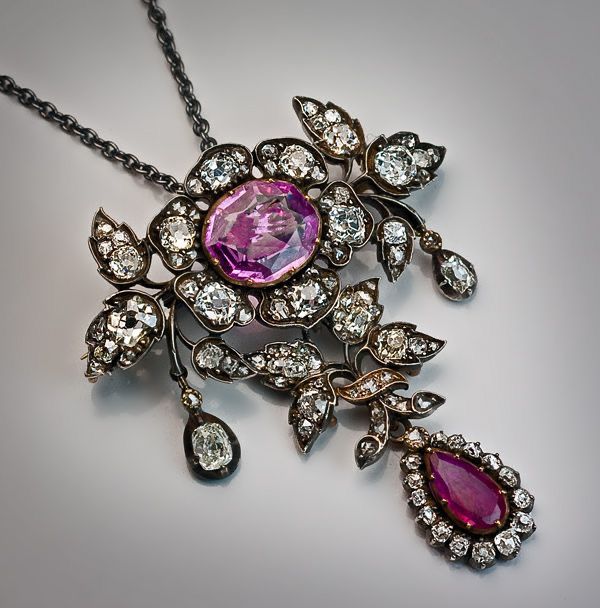 a decorative drop pendant with pink and dark-toned accents
