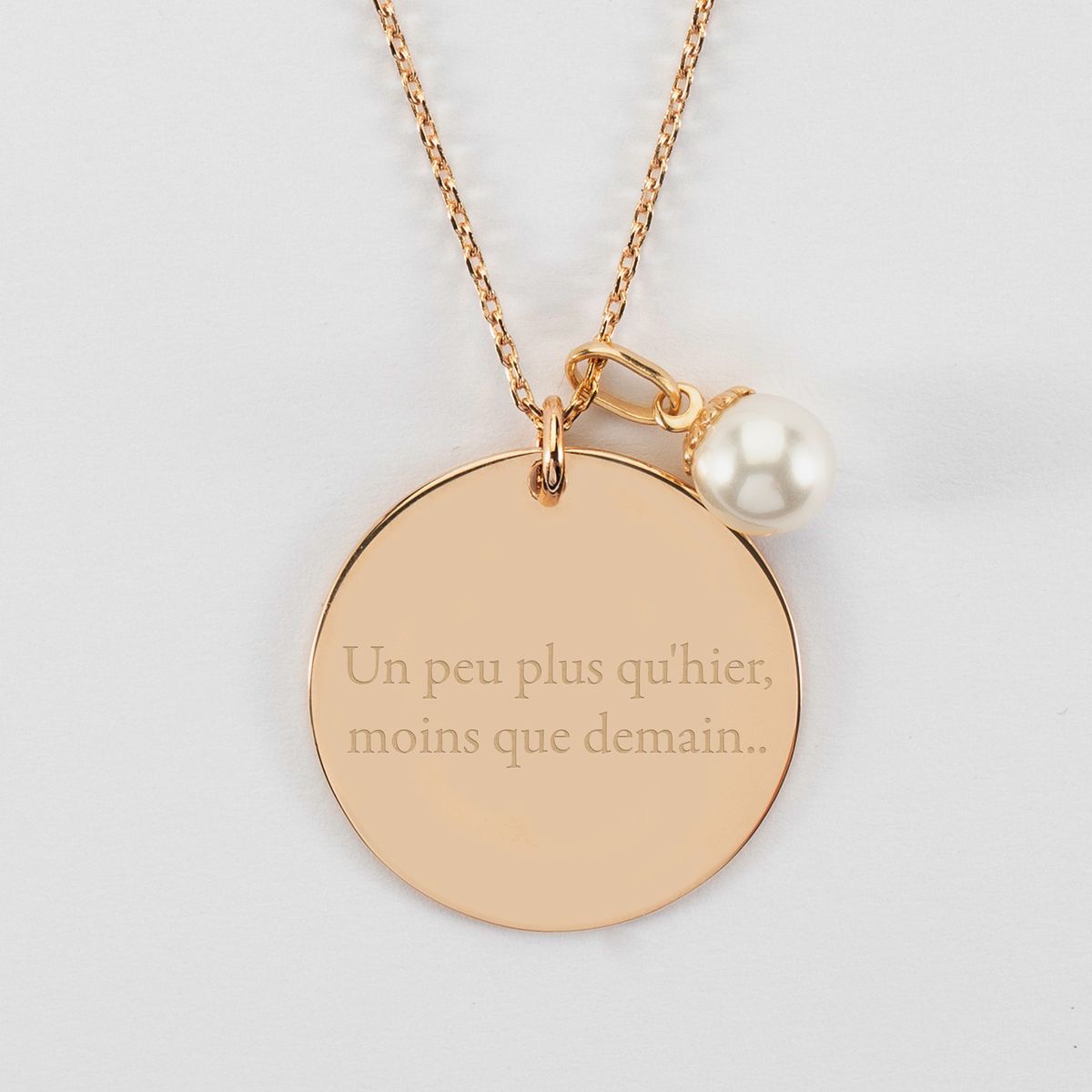 a round medallion pendant with a short visible inscription