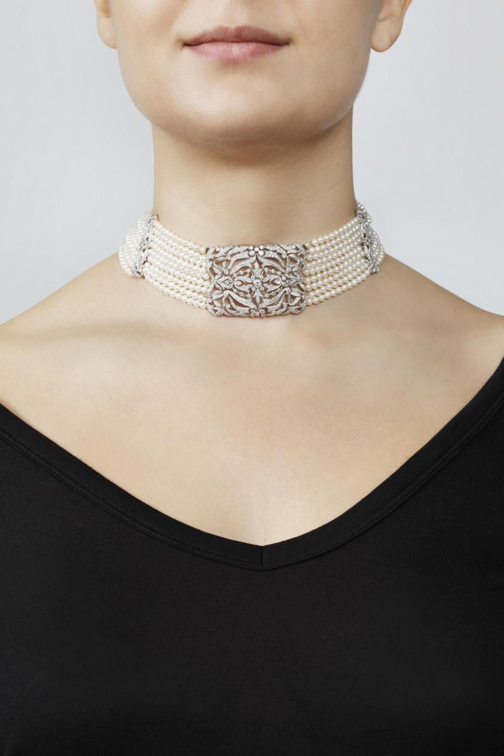 a close-fitting band with rows of pale round accents
