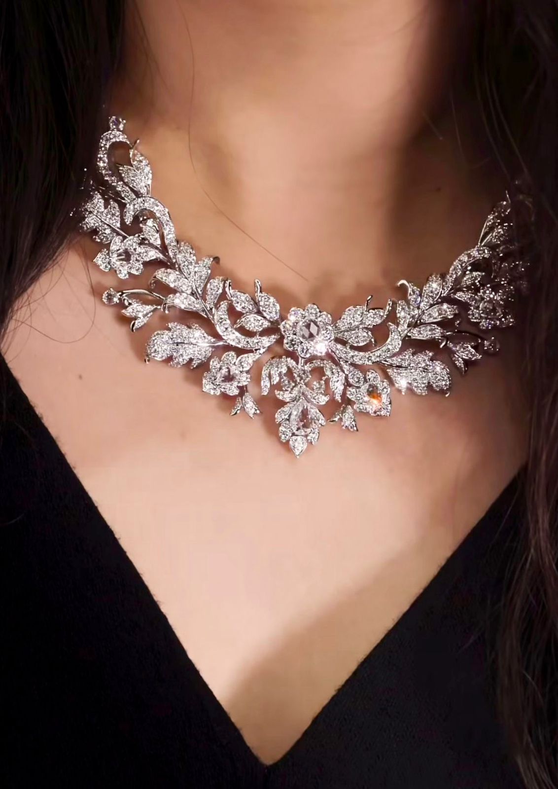 a curved necklace with flower-like bright details