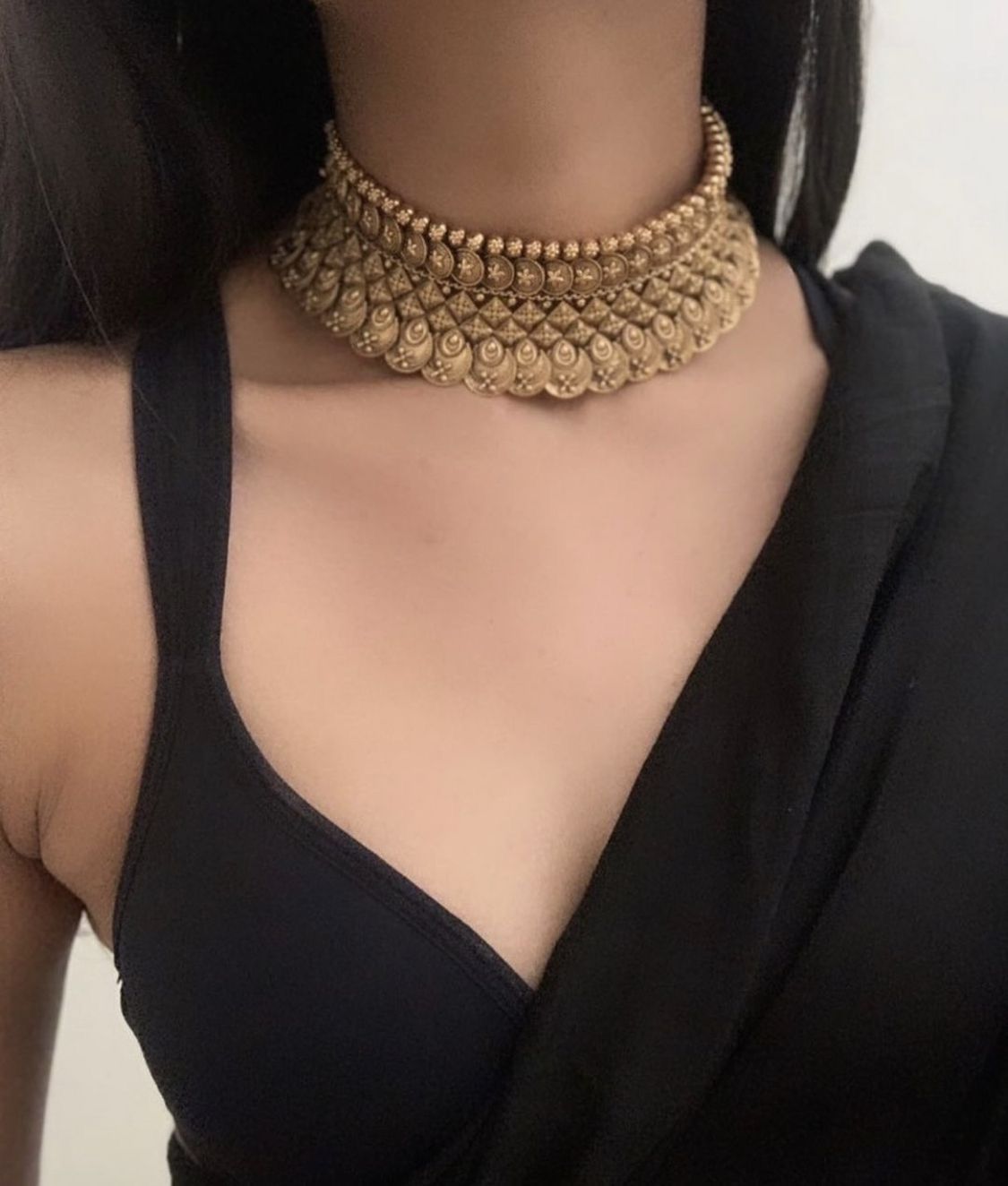 a close-fitting collar with a round center detail
