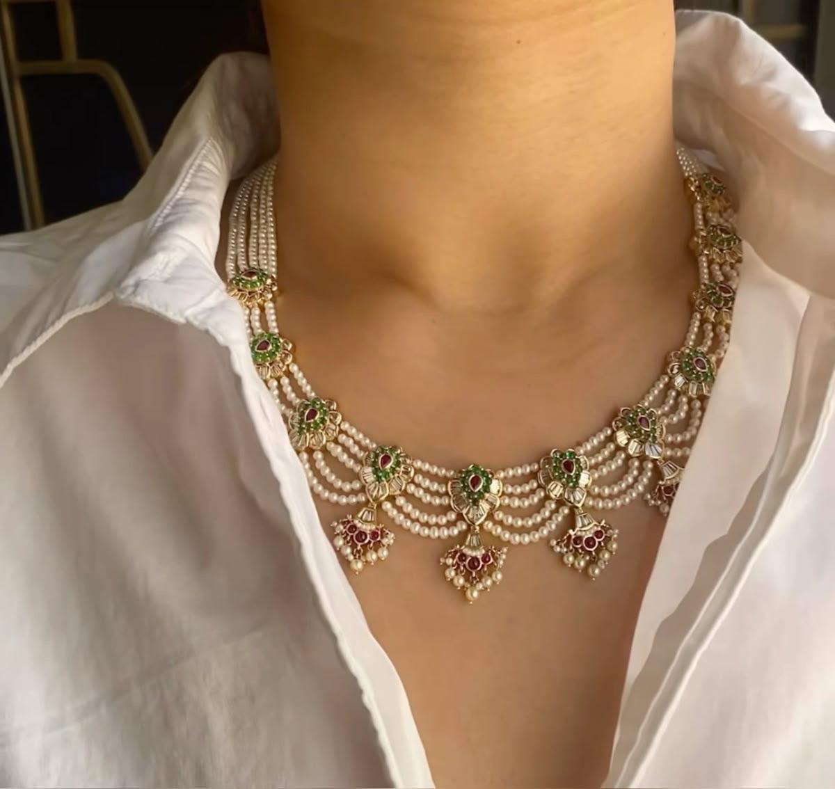a layered neckline design with green-toned details