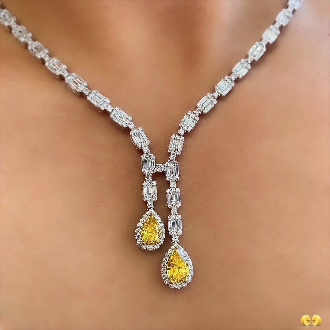 a fine chain with a bright yellow-toned center drop