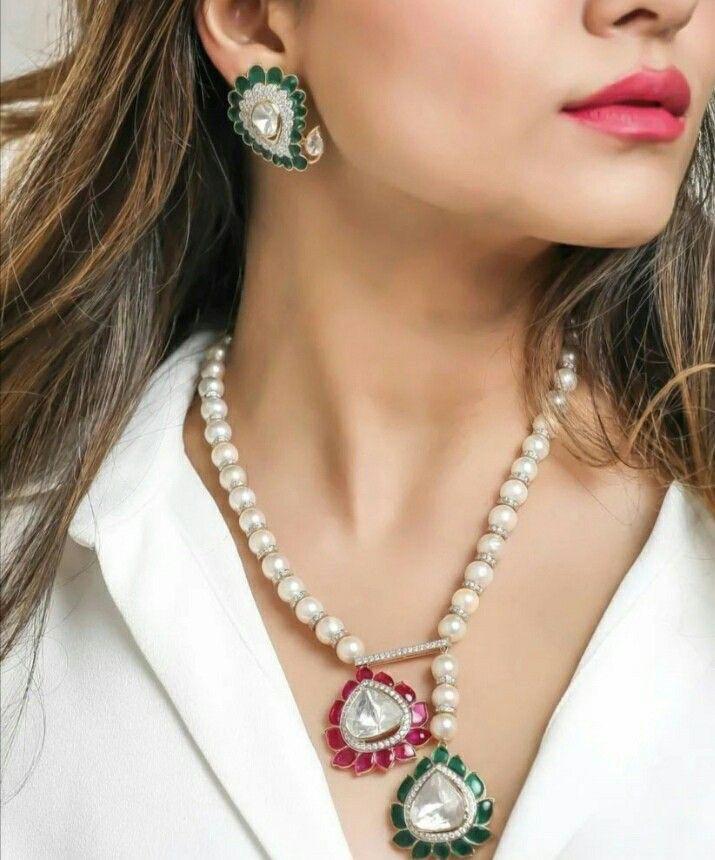 a pendant necklace shown with matching earrings