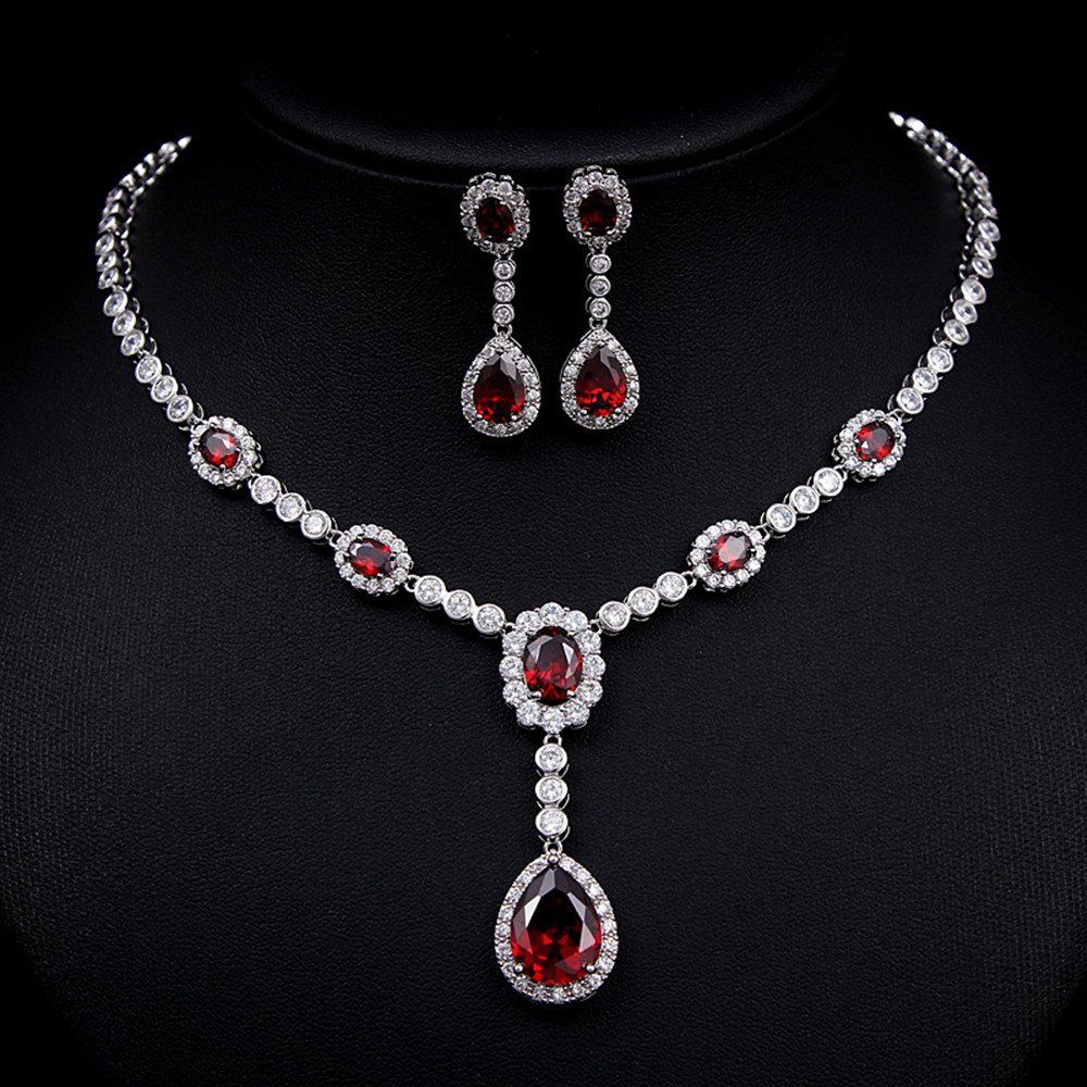 a necklace shown with matching earrings
