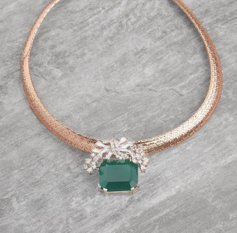 a centered green-toned detail on a fine chain