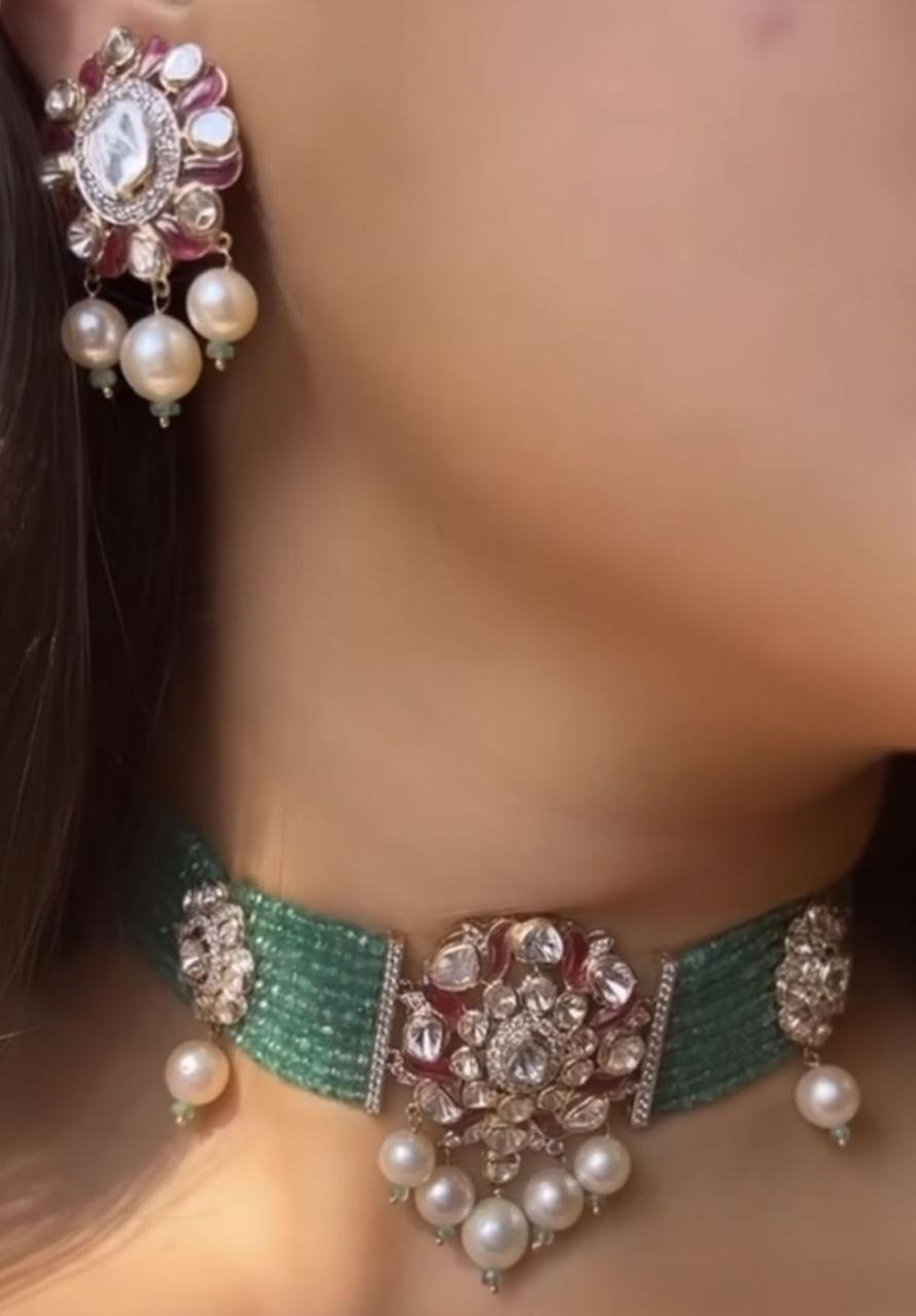 a necklace shown with matching earrings