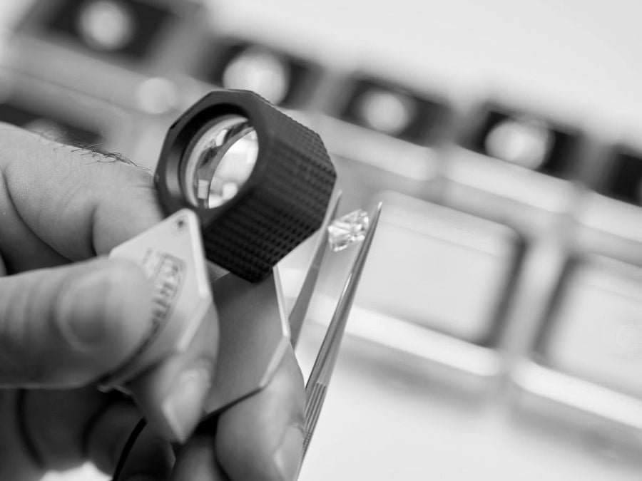 A diamond examined under a loupe