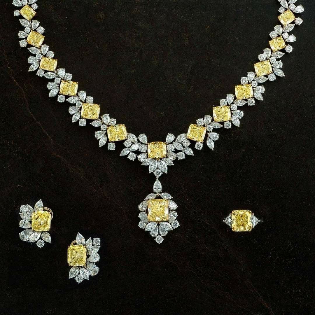 A coordinated necklace and matching pieces with yellow-toned floral motifs.