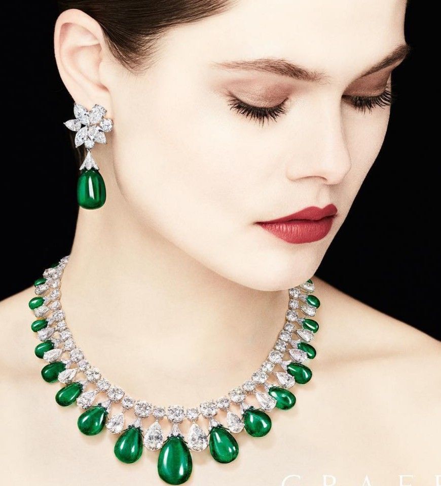A necklace with green-toned drops, shown with matching earrings.