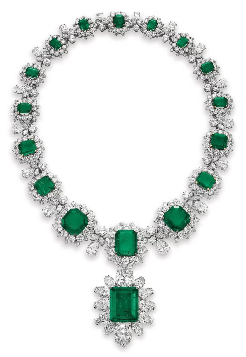 A necklace with a square green-toned pendant and matching geometric details.
