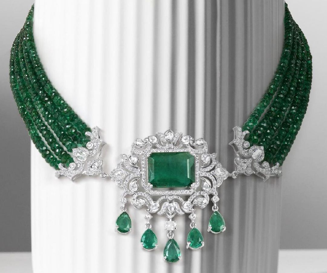 A wide bracelet with green-toned rows and a central square detail.