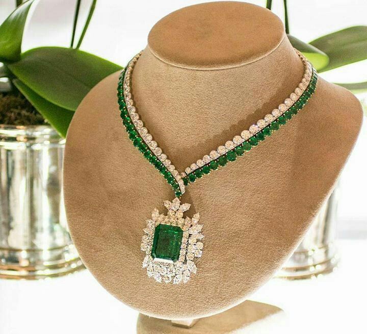 A multirow necklace with green-toned accents and a large rectangular center pendant.