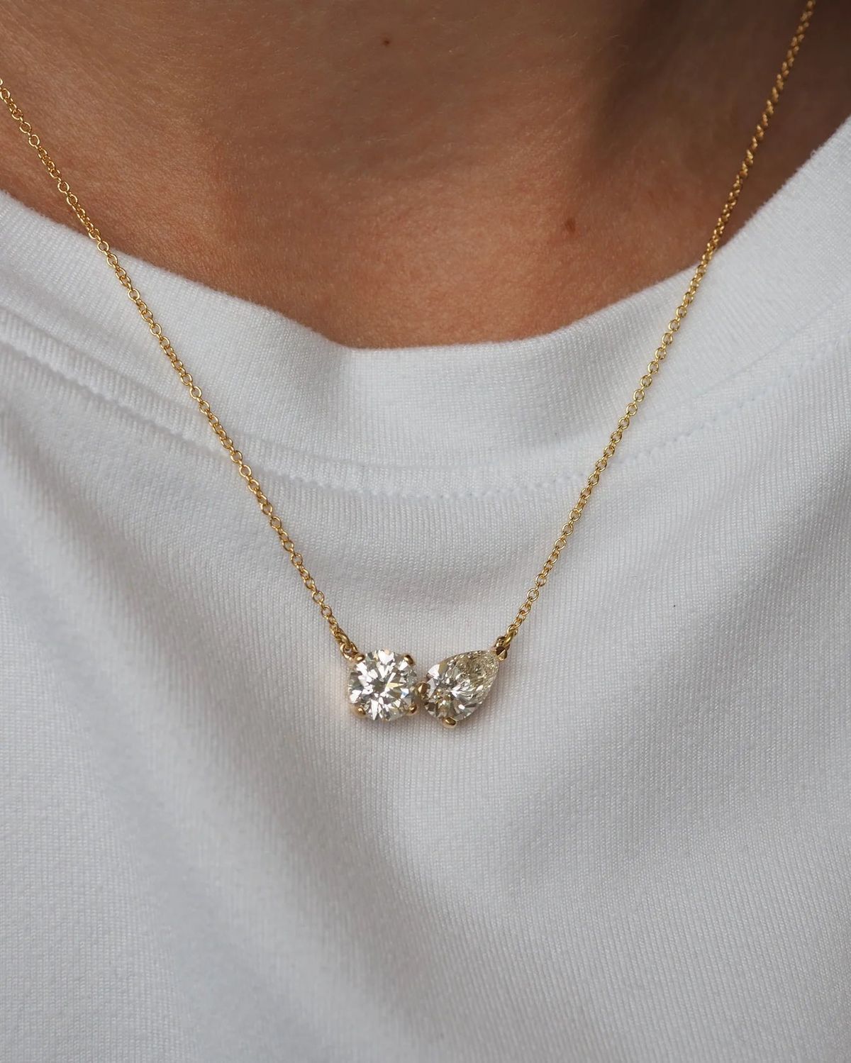 A fine chain necklace with a small cluster pendant.