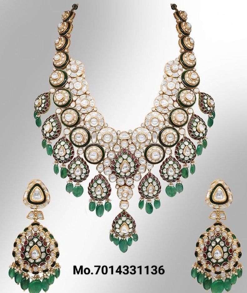 A broad necklace with green-toned details, shown with matching drop earrings.