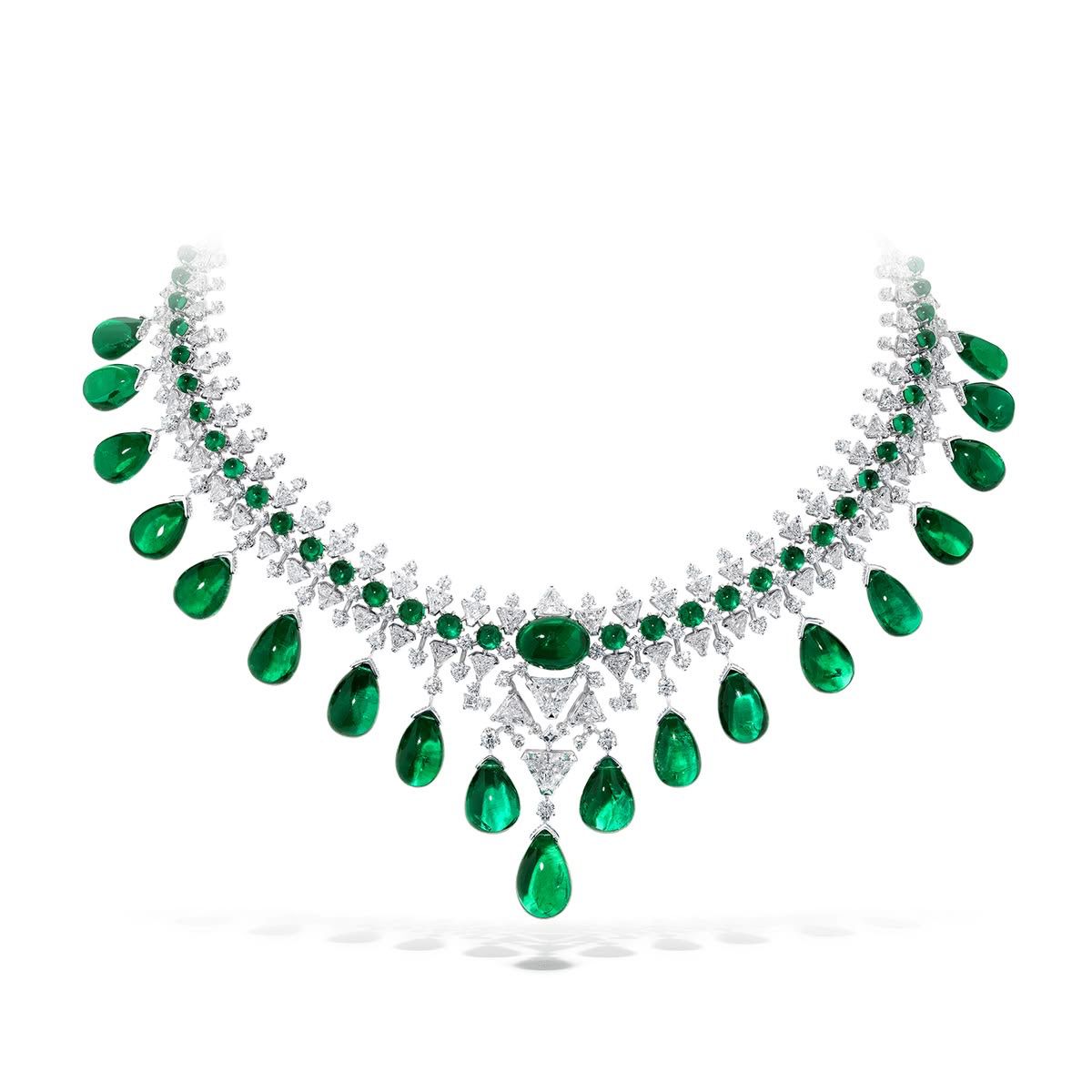 A pale curved necklace with green-toned round and drop-shaped details.