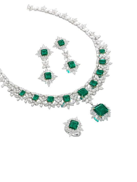 A necklace with green-toned square details, shown with matching earrings and other pieces.