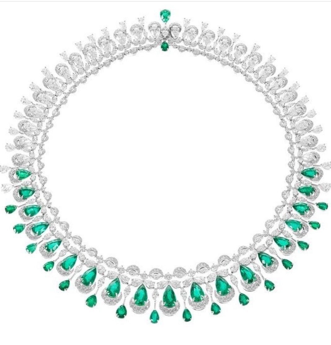 A pale collar necklace with evenly spaced green-toned teardrop details.