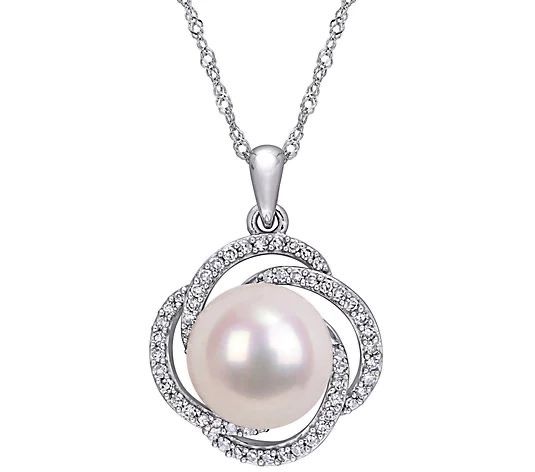 A pendant necklace with a large pale round center and a circular frame.