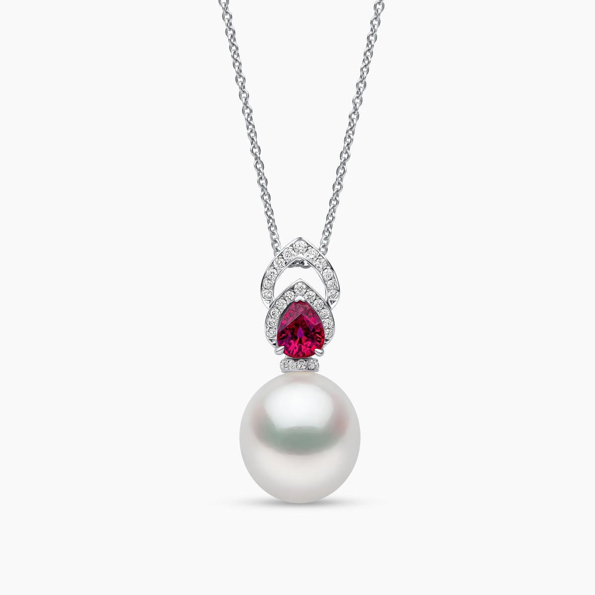 A necklace with a pale round pendant and a small red-toned accent.