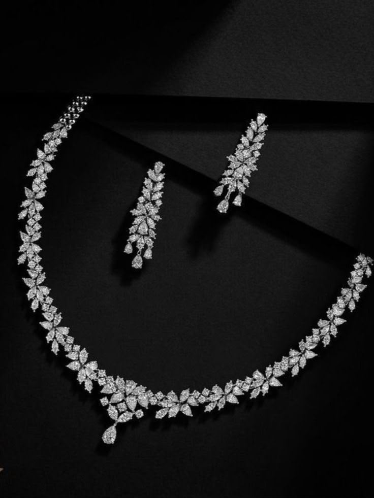 A curved necklace with matching long drop earrings.