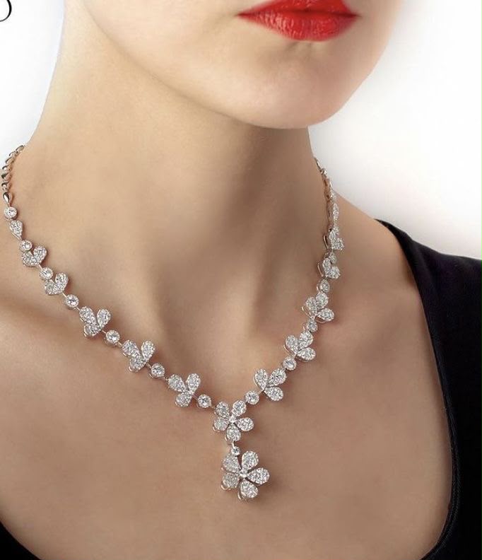 A fine necklace with a small floral center pendant and pale details.
