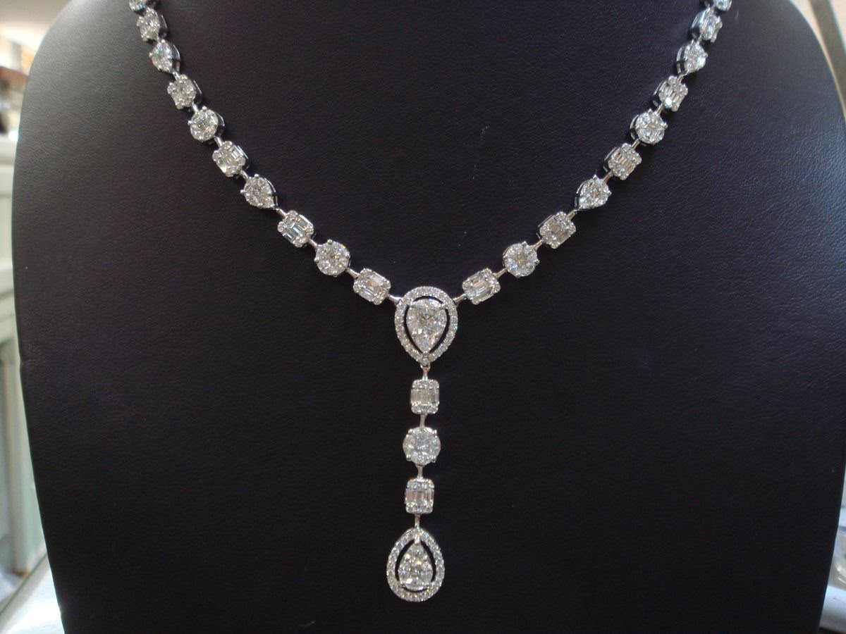 A fine necklace with a long heart-shaped center drop.