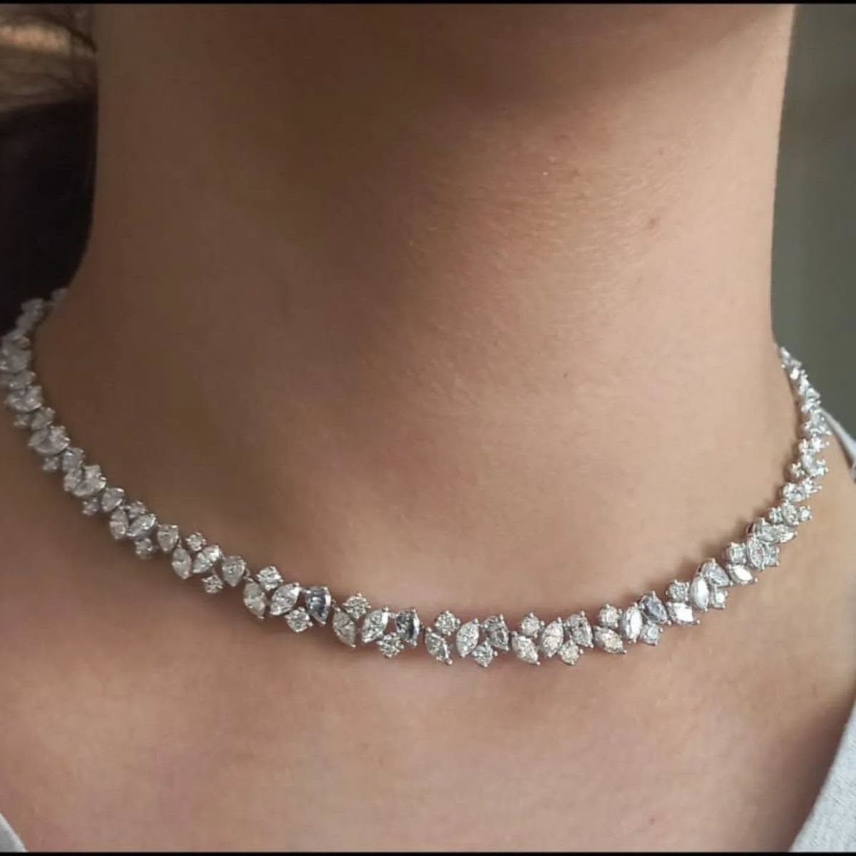 A short necklace with a repeating row of pale geometric details.