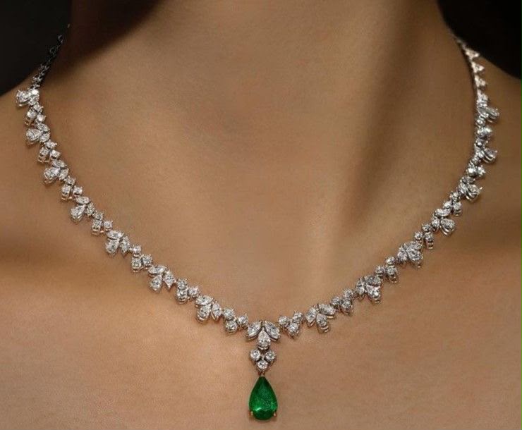 A fine necklace with a green-toned teardrop pendant.