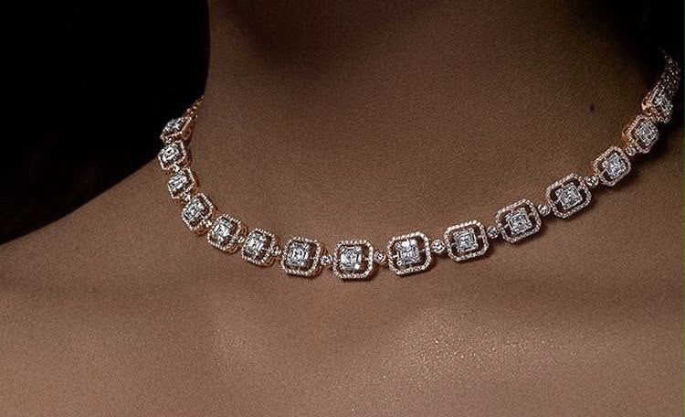 A short necklace with square framed details arranged in a single row.