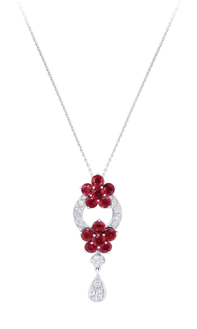 A fine necklace with a red-toned cluster pendant and a small drop.