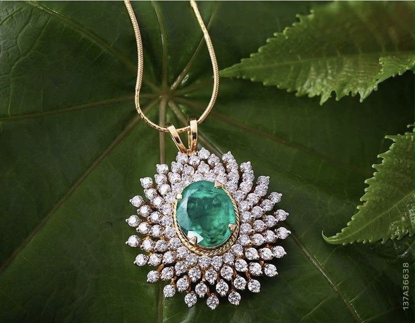 A necklace with a round green-toned center framed by pale details.