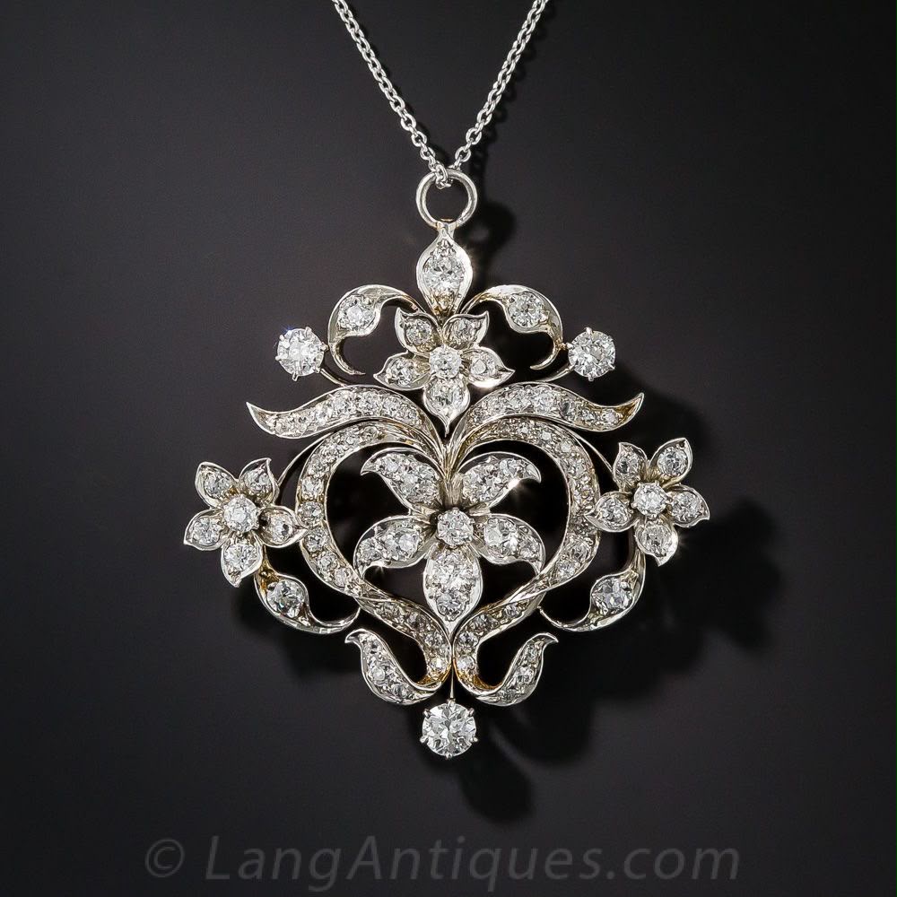 A pendant with a round floral scroll design and a small top connector.